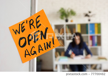 We are open again sign about reopening after quarantine. 77700482