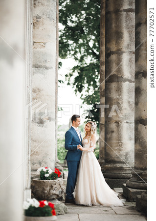 Wedding couple holding hands, groom and bride together on wedding day Wedding couple holding hands, groom and bride together on wedding day 77702571