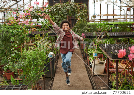 Boy playing in the garden Boy playing in the garden 77703631