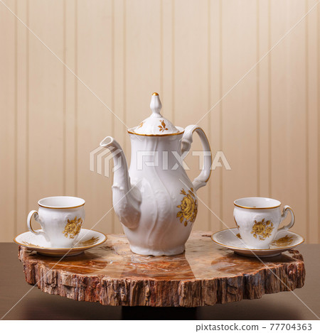 Elegant coffee set on an exclusive tray Elegant coffee set on an exclusive tray 77704363