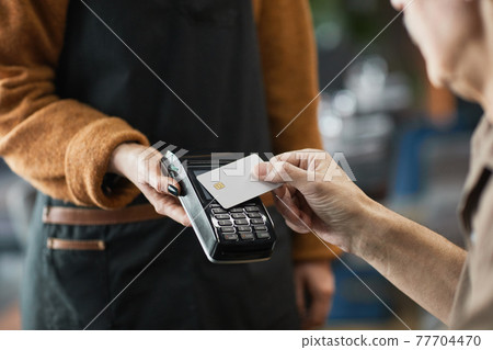 Cafe customer paying with credit card with NFC 77704470