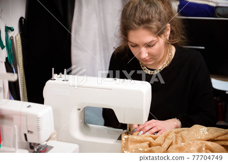 Process of sewing in atelier or workshop. Tailoring and repair of clothing, self-employed employee. 77704749
