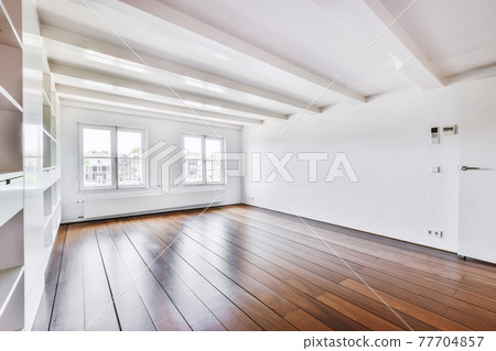 Empty shelves on wall in spacious room Empty shelves on wall in spacious room 77704857