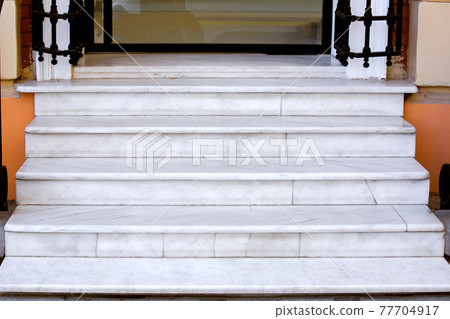 white marble staircase with stone steps at the threshold of the store entrance with glass door close-up of architecture, nobody. white marble staircase with stone steps at the threshold of the store entrance with glass door close-up of architecture, nobody. 77704917