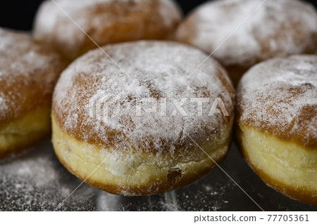 Chocolate or jelly filled donuts sprinkled with powder sugar Chocolate or jelly filled donuts sprinkled with powder sugar 77705361