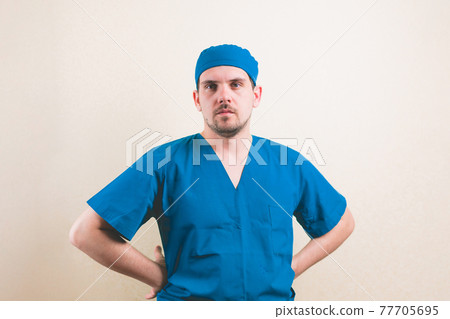 Young doctor portrait with hands on hips Young doctor portrait with hands on hips 77705695
