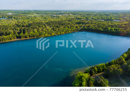Scenic view of a lake water landscape scene between green forest Scenic view of a lake water landscape scene between green forest 77706255