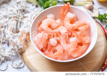 Shrimp peeled on white bowl ready for cooking, Fresh shrimps or prawns seafood and shellfish 77707670