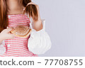 Closeup hand holding comb and hair fall problem isolated grey background. 77708755