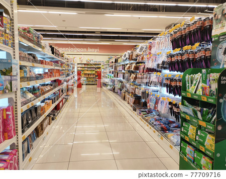 SEREMBAN, MALAYSIA -MARCH 2, 2021: Interior of a hypermarket. Daily necessities and groceries are displayed on sales shelves and price tagged. Sorted by type and brand. 77709716