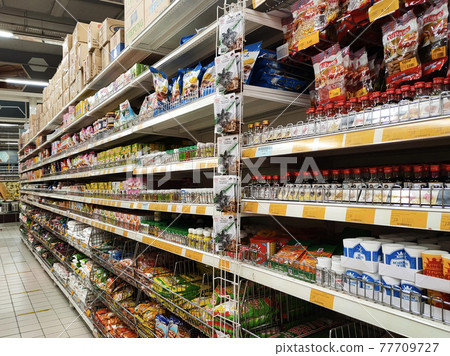 SEREMBAN, MALAYSIA -MARCH 2, 2021: Interior of a hypermarket. Daily necessities and groceries are displayed on sales shelves and price tagged. Sorted by type and brand. 77709727
