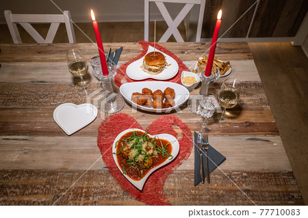Valentines day dinner setting romantic love for two wooden table red heart shape candle light with Burger and Pasta Valentines day dinner setting romantic love for two wooden table red heart shape candle light with Burger and Pasta 77710083