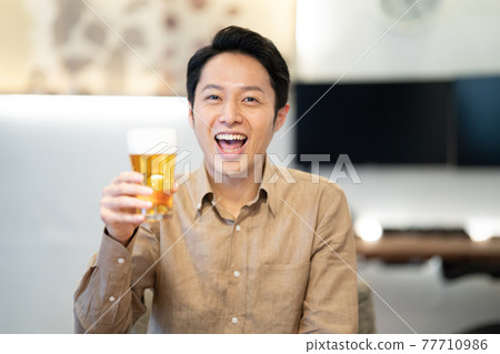 Men enjoying an online drinking party Men enjoying an online drinking party 77710986