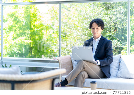 A man teleworking on the terrace. Shooting cooperation "+ SHIFT NOGIZAKA" A man teleworking on the terrace. Shooting cooperation "+ SHIFT NOGIZAKA" 77711855