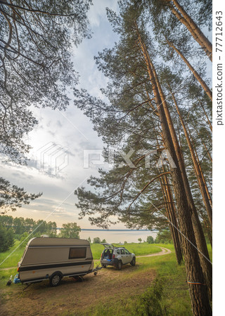 camper in the forest by the lake camper in the forest by the lake 77712643