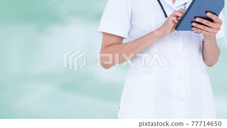 Midsection of doctor using digital tablet over green background, healthcare and technology concepts 77714650