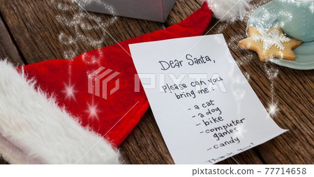 Composition of letter to santa over santa claus hat and christmas decorations 77714658
