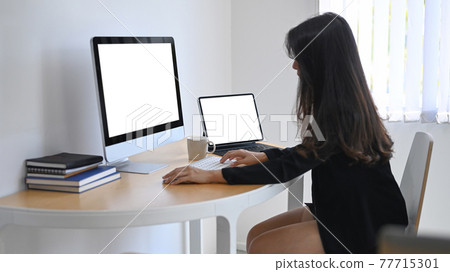 Mock up computer laptop, smart phone, dumbbells and bottle of water on wooden floor. Fitness online training 77715301