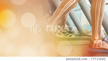 Composition of spots of light over man running on treadmill with bones showing Composition of spots of light over man running on treadmill with bones showing 77715680