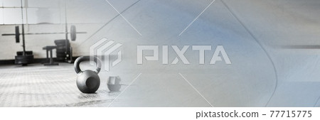 Composition of kettlebell on gym floor with blurred grey light Composition of kettlebell on gym floor with blurred grey light 77715775