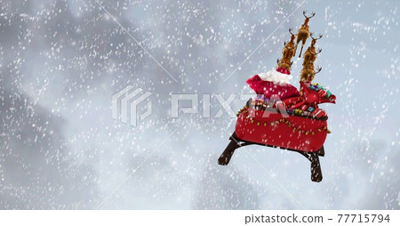 Composition of santa claus in sleigh pulled by reindeer on snowfall and clouds background 77715794