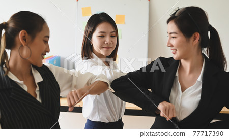 Women are greeting each other with the elbow. Elbow bumps greeting style to prevent contact and virus spread. Women are greeting each other with the elbow. Elbow bumps greeting style to prevent contact and virus spread. 77717390