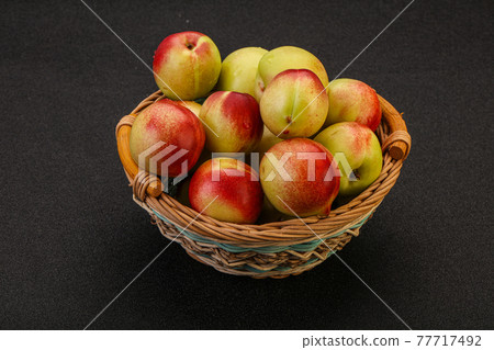 Sweet small nectarines in the basket 77717492