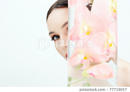 Beautiful young Woman and Flowers in the Bottle Beautiful young Woman and Flowers in the Bottle 77719057