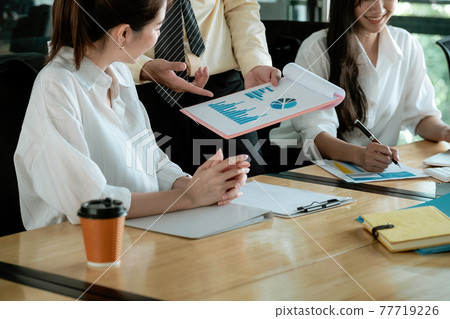 Business advisor working together in the office discussing documents and ideas at meeting Business advisor working together in the office discussing documents and ideas at meeting 77719226
