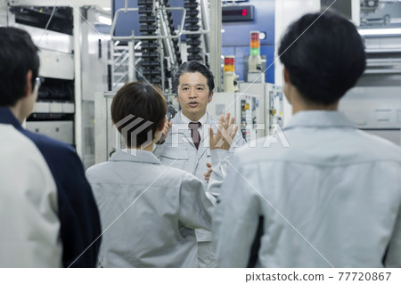 Female worker asking questions at a meeting Factory morning assembly 77720867