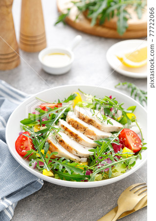 Chicken breast salad. Fresh vegetable salad with tomato, pepper, arugula and grilled chicken breast in bowl, healthy food. Chicken breast salad. Fresh vegetable salad with tomato, pepper, arugula and grilled chicken breast in bowl, healthy food. 77722066