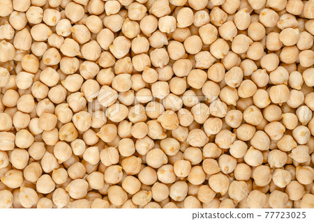 Dried chickpeas, background from above. Whole and light tanned chick peas, a high in protein legume and fruit of Cicer arietinum. Key ingredient in hummus and chana masala. Backdrop. Macro food photo. 77723025