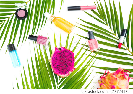 Beauty composition with tropical fruits, palm leaves and female cosmetics with aroma on white. Flat lay, top view. Beauty composition with tropical fruits, palm leaves and female cosmetics with aroma on white. Flat lay, top view. 77724173