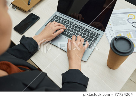 Person working on a laptop 77724204