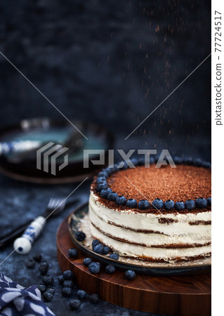 Delicious homemade sour cream vanilla cake decorated with chocolate and fresh blueberry 77724517
