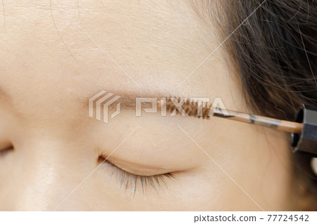 Woman getting make-up Woman getting make-up 77724542