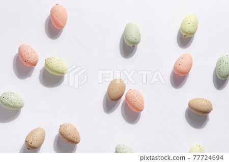 Happy Easter holiday background with colorful pastel eggs on white paper . Happy Easter holiday background with colorful pastel eggs on white paper . 77724694