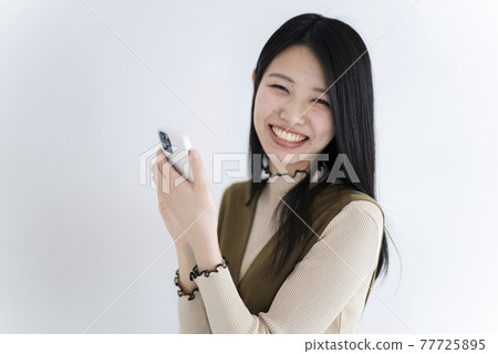 Woman using a smartphone Woman using a smartphone 77725895