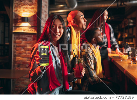 Group of friends watching sport match together. Concept of friendship, leisure activity, emotions 77727199