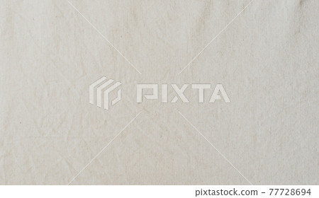 Abstract textile background from natural linen fabric of light color. Copy space 77728694