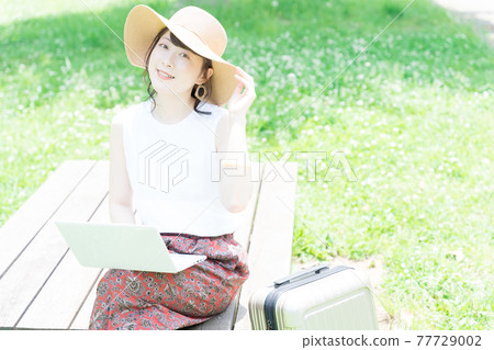 A young woman worcation in the fresh green 77729002