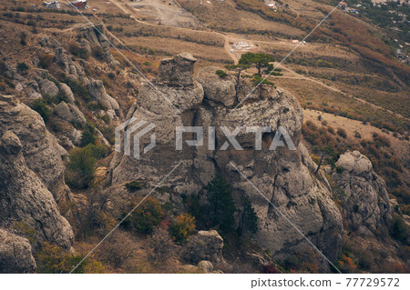 Grand stone pillars on the slopes of Mount Demerdzhi. Valley of ghosts, Crimean Mountains. Grand stone pillars on the slopes of Mount Demerdzhi. Valley of ghosts, Crimean Mountains. 77729572