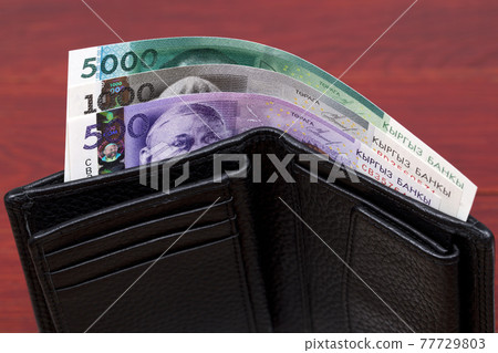 Kyrgyzstani money - som in the wallet 77729803
