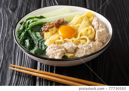 Singapore style homemade noodle soup with fried anchovies, meatballs, egg and bok choy close-up in a bowl. horizontal Singapore style homemade noodle soup with fried anchovies, meatballs, egg and bok choy close-up in a bowl. horizontal 77730583