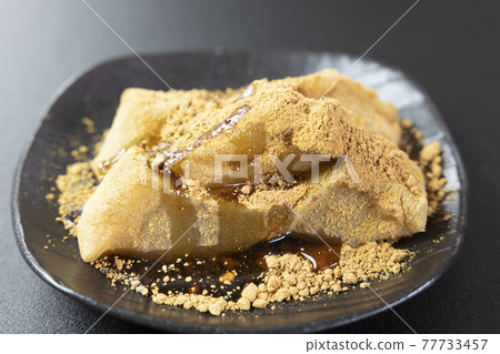 正宗的芥末麻糬撒上美味的黃豆粉，再撒上黑蜂蜜 77733457