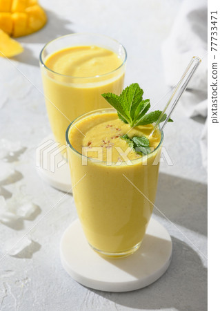 Indian mango or turmeric lassi on gray background 77733471