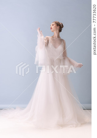 Young woman in art action isolated on white background. Retro style, comparison of eras concept. Young woman in art action isolated on white background. Retro style, comparison of eras concept. 77733620