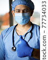 male surgeon in face mask with arms 77734033
