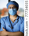 male surgeon in face mask with arms 77734035