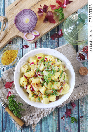 German cuisine. Potato salad with red and green onions, mustard and olive oil sauce 77735538